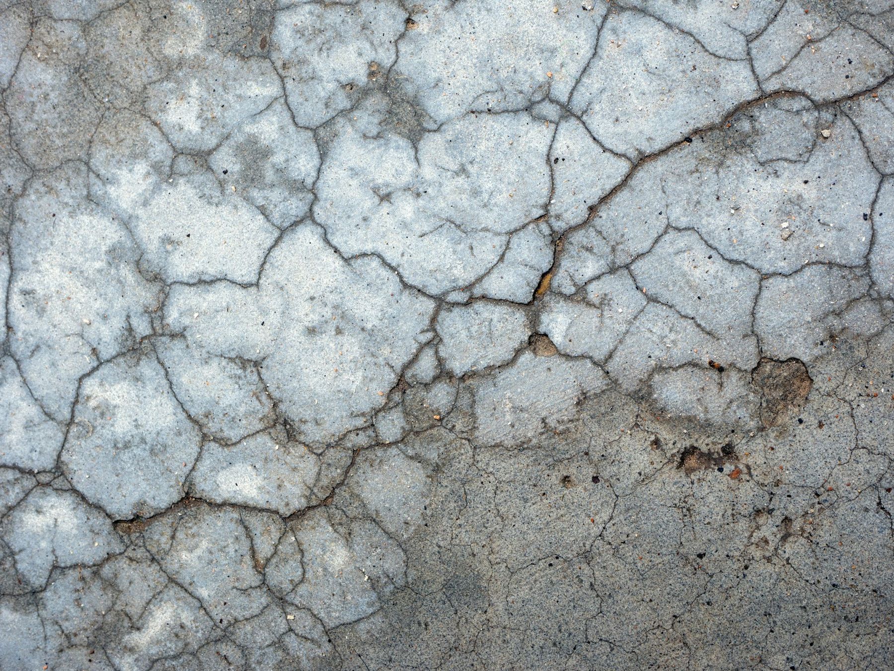 Cracked and worn concrete slab before repair